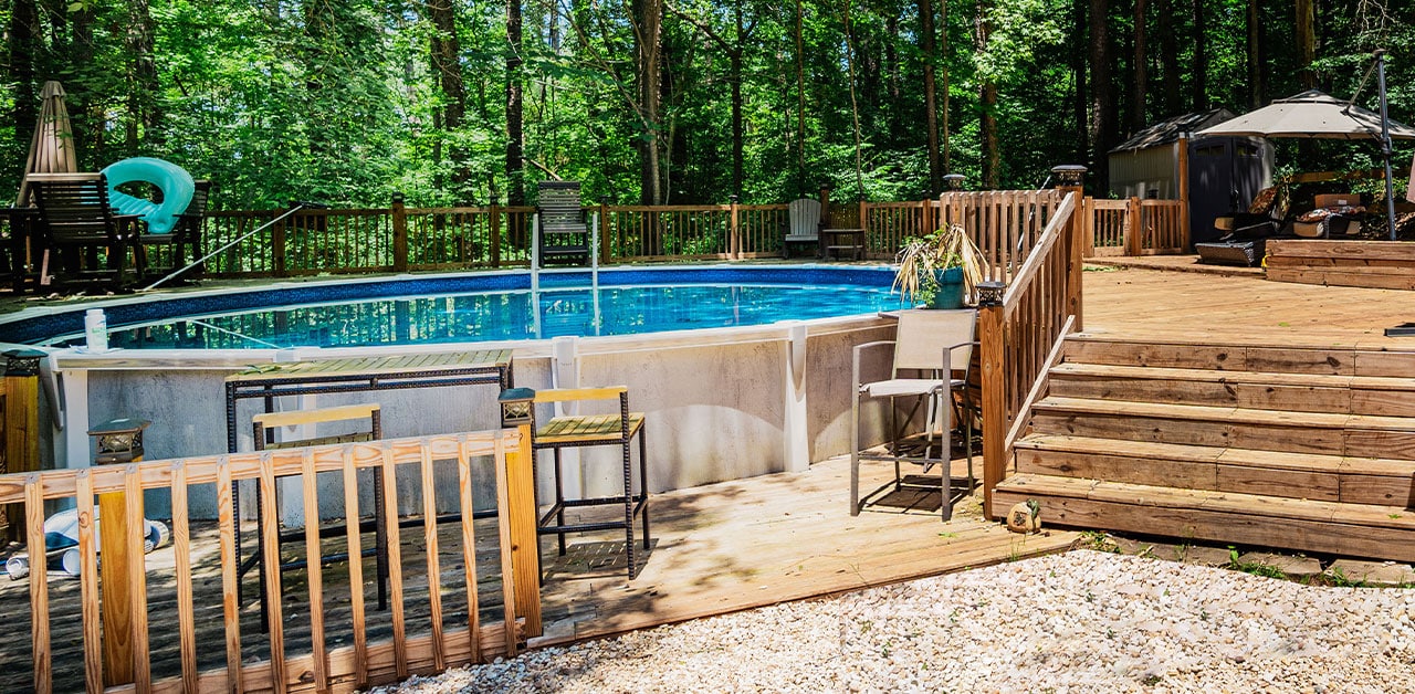 Featured image of the Hilary project showing above-ground pool in wooded setting